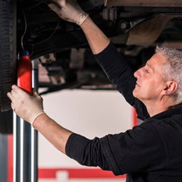 service tech checking vehicle